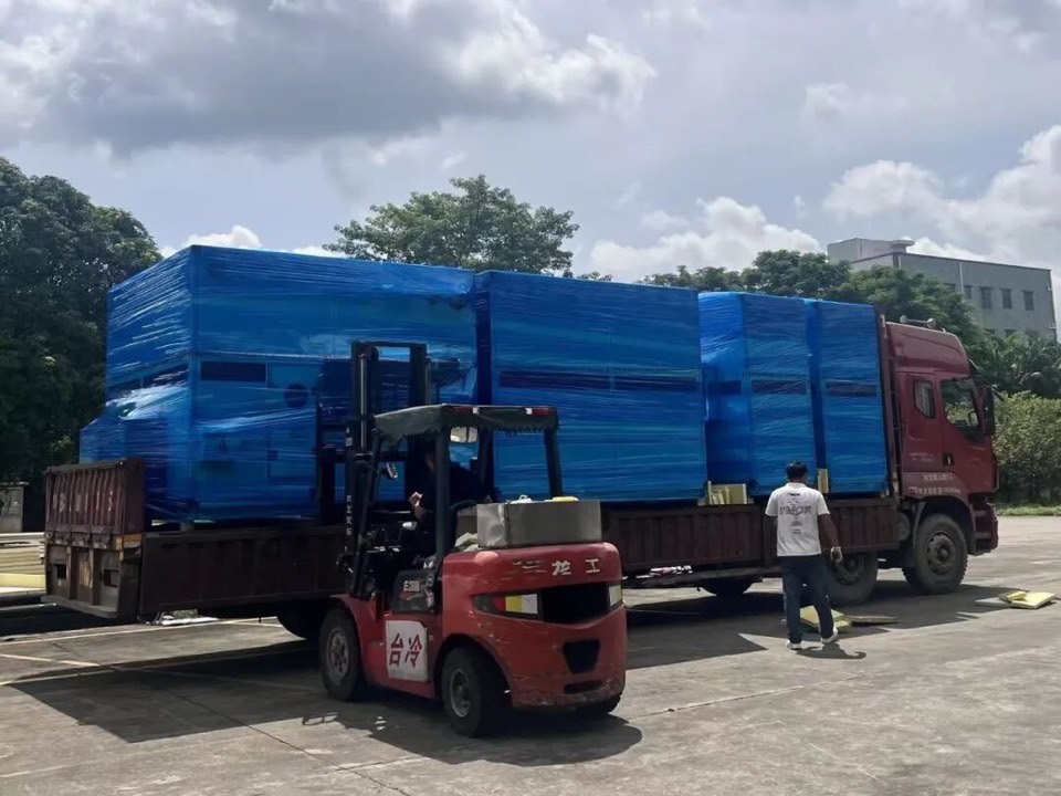 Taile forklift loading wrapped air handling units onto a truck at the factory